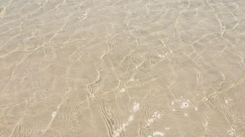 Small wave of water on clear sandy beach Stock Footage 54592164