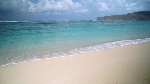 Small wave white sand beach, Ocean Wave On Sandy Beach Stock Footage 128410718