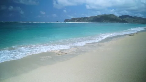 Small wave white sand beach, Ocean Wave On Sandy Beach Stock Footage 128411537