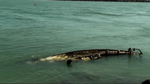 Small waves around a sunken sailboat Stock Footage 37671606