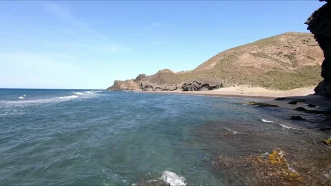 Small waves arriving at an remote beach Stock Footage 279178396
