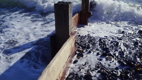 Small waves on a beach groin Stock Footage 141112261