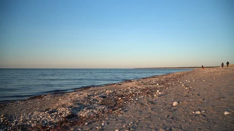 Small waves on beach with people Stock Footage 127934451