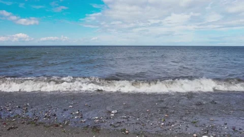 Small waves on the beach at the river Stock Footage 130880323