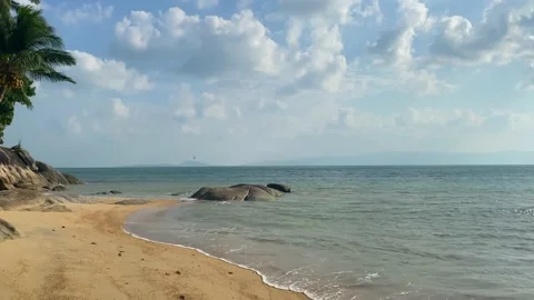 Small waves beat against the beautiful sandy shore. Stock Footage 230083459