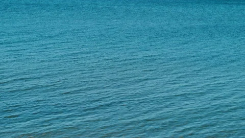 Small waves on beautiful blue lake Stock Footage 239456236