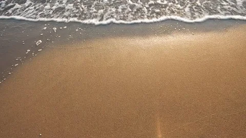 Small waves break on the shoreline at sunset Stock Footage 105201269