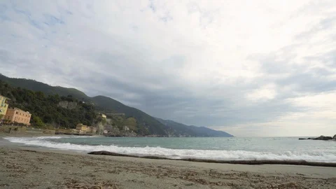 Small waves breaking on beach in Rio Maggiore on cloudy day Stock Footage 103294530