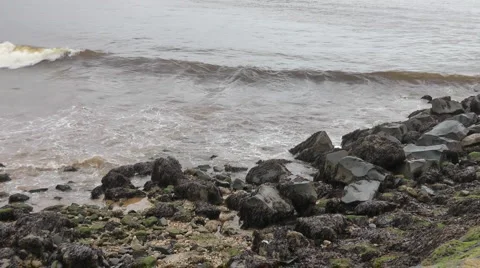 Small waves breaking over rocks at side of breakwater. Stock Footage 1091280
