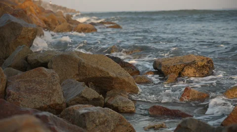 Small waves breaking over rocks Stock Footage 32136407