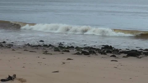 Small waves breaking over rocky beach on windy winter's day. Stock Footage 1091207