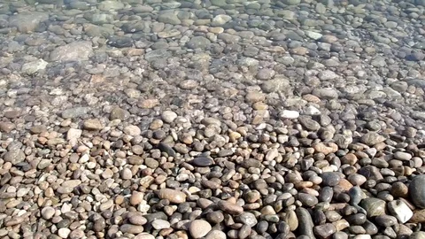 Small waves breaking in the pebbles Stock Footage 69885576