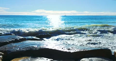 Small waves breaking on the reefs in the Italian sea Stock Footage 240470730