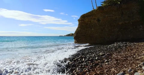 Small waves breaking on the reefs in the Italian sea Stock Footage 241073152