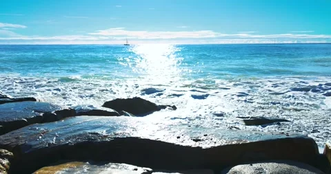 Small waves breaking on the reefs in the Italian sea Stock Footage 241073171