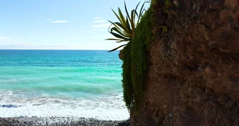 Small waves breaking on the reefs in the Italian sea Stock Footage 242236513
