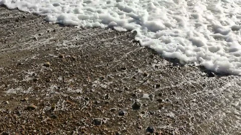 Small waves breaking on shingle beach Video stock 86512448