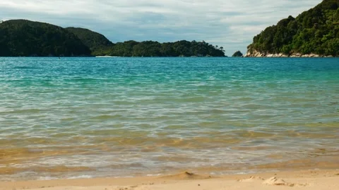 Small waves breaking on shore in bay Stock Footage 260369953