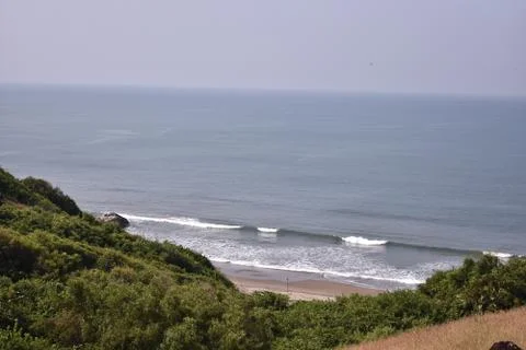 Small waves breaking through in a ocean,between the landscape. Stock Photos
