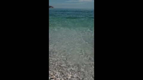 Small waves in clear blue sea. Sea beach landscape. Stock Footage 316920476