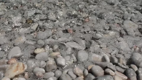 Small waves in clear blue sea. Pebble stone beach. Stock Footage 316920496