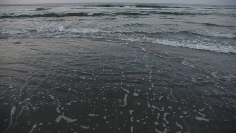 Small waves crash along the beach Video stock 74665014