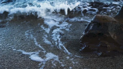 Small Waves Crash on Rocks at Beach Close Up SLOW MOTION Stock Footage 101212190
