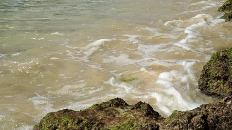Small waves crashing against rocks Video stock 287606646