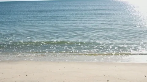 Small waves crashing on the beach during the summer Stock-Footage 76591399