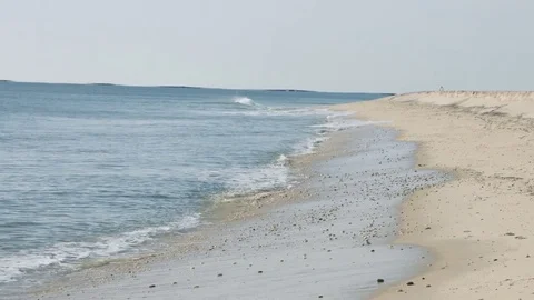 Small waves crashing on the beach during a bright summer day Video stock 76591456