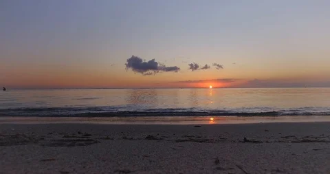 Small waves crashing on the beach at sunset Stock Footage 95325950