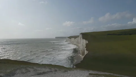 Small waves crashing onto the coastline of a row of white cliffs. Stock Footage 114775298