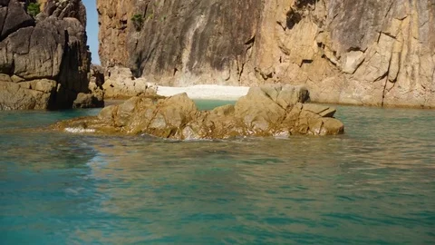 Small waves crashing a rock formation Stock Footage 80472065