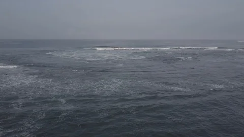 SMALL WAVES CRASHING ROCKS AND SKY | AERIAL, EXT, WIDE, TRACKING FWD | 2398 | 4K Stock Footage 105030254