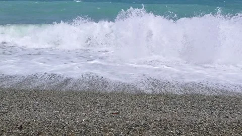 Small waves crashing onto a tropical pebble beach - Looc Surigao City Stock Footage 313526442