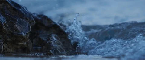 Small waves crushing on rocks  in slowmotion, sea at night, blue hour Stock Footage 97901159