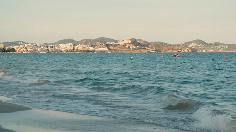 Small waves on empty beach and sea at Playa d'en Bossa in Ibiza, Spain Stock Footage 129554647