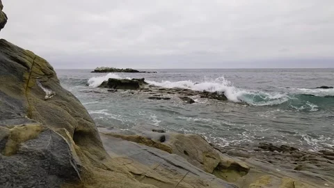 Small Waves Gently Crash on the Rocks in Laguna Beach Stock Footage 288408286