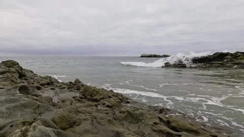 Small Waves Gently Crash on the Rocks in Laguna Beach Stock Footage 288408393