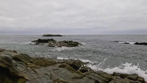 Small Waves Gently Crash on the Rocks in Laguna Beach Stock Footage 288408394