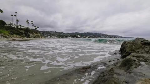 Small Waves Gently Crash on the Sand in Laguna Beach Stock Footage 288408423