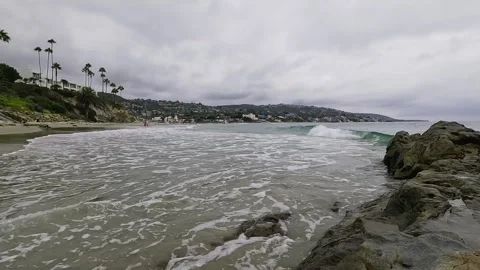 Small Waves Gently Crash on the Sand in Laguna Beach Stock Footage 288408478