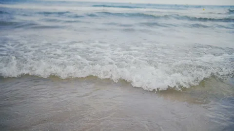 Small waves goes on camera in slow-motion Stock Footage 64961229