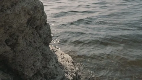 Small waves hit the rock Stock Footage 257539285