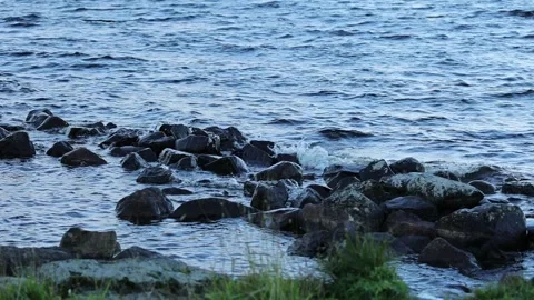 Small waves hit the rocky shore Stock Footage 245359862