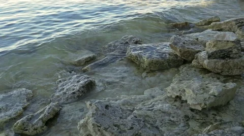 Small waves hitting rock shore Stock Footage 57170695