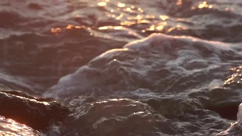 Small waves hitting rock shore Stock Footage 77805102
