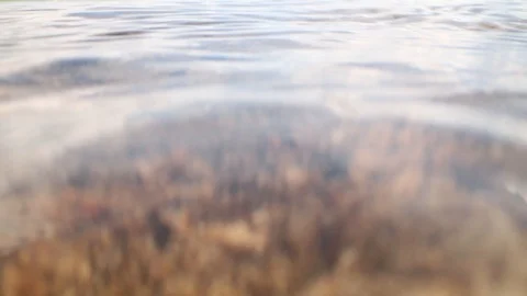 Small waves hitting rocky shore underwater Stock Footage 109604060