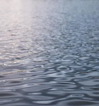 Small waves illuminated by sunlight Stock Photos