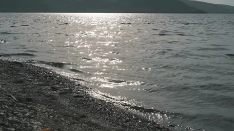 Small waves on the lake. View of the hills Stock Footage 256216031